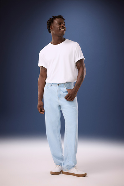 Modelo veste camiseta branca, calça jeans skater azul e tênis off white 