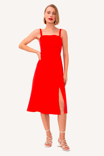 Modelo veste vestido de viscose vermelho com fenda lateral