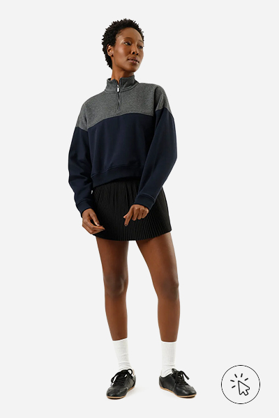 Modelo veste blusão feminino de moletom com recorte gola alta azul-marinho